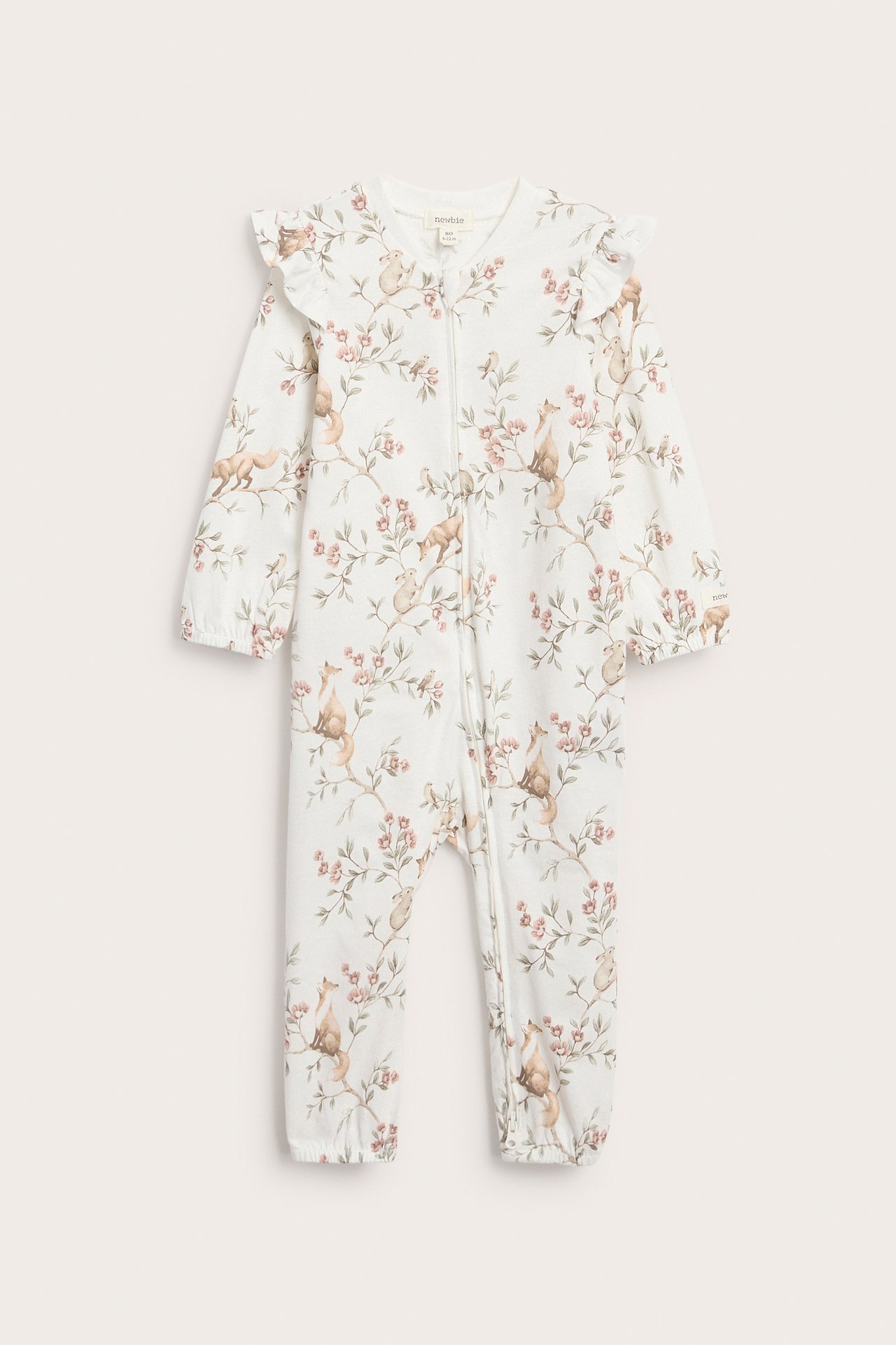 Front view: Off-white cotton baby pyjamas with forest animal print, ruffles, elastic cuffs, and a zipper.