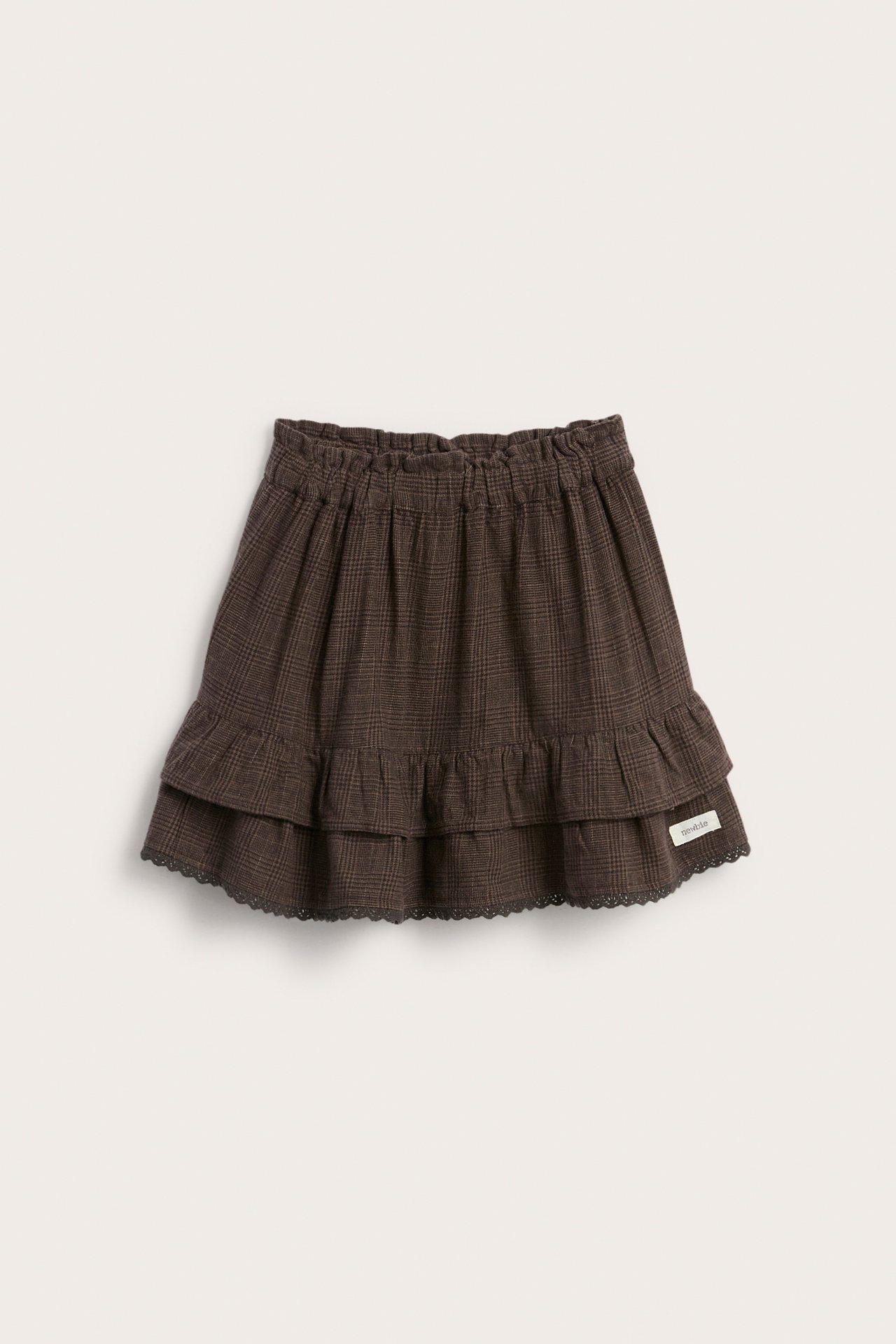 Front view of a kid's dark brown plaid ruffled skirt with an elasticated waist and scalloped trim.