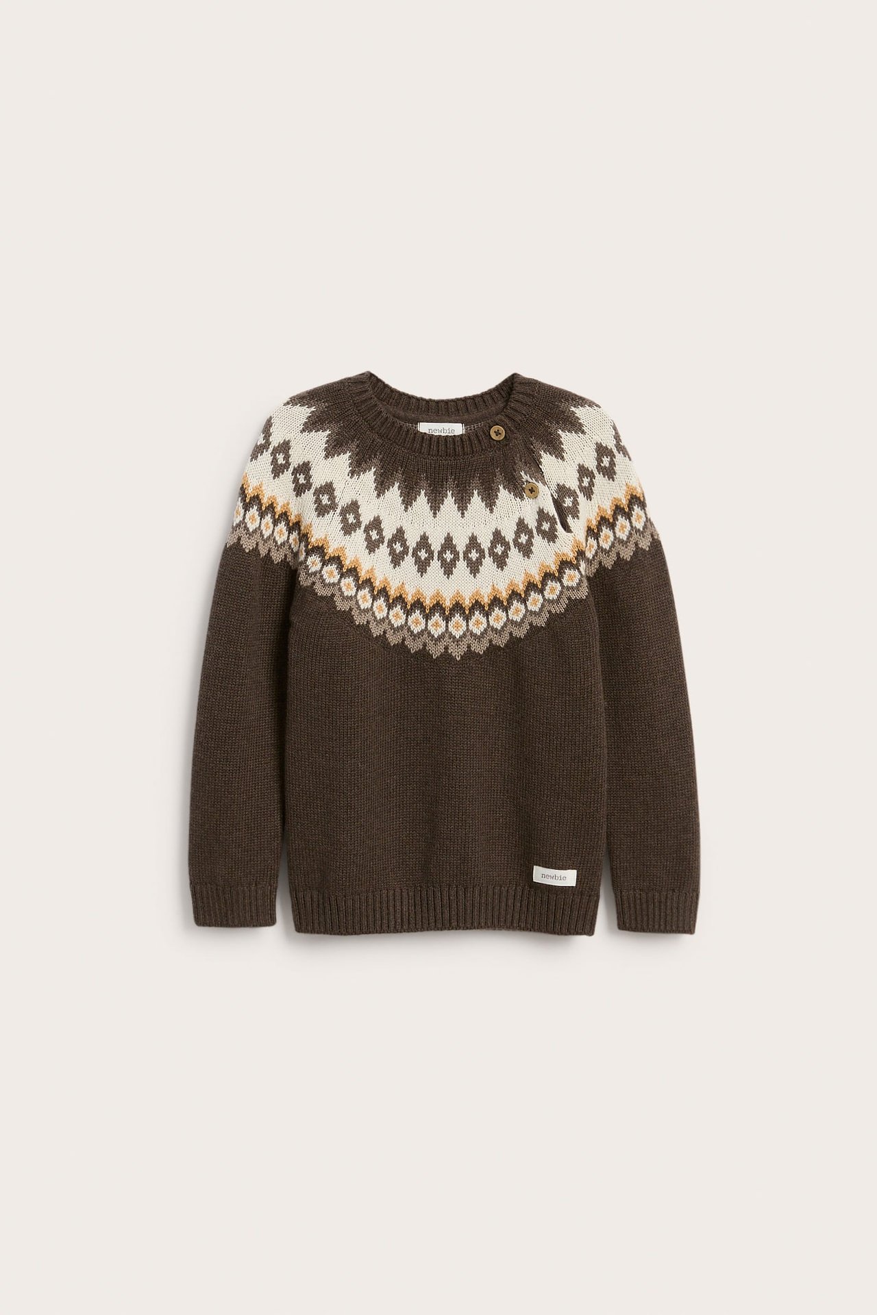 Front view of a kid's brown knit fair isle sweater with shoulder buttons and a label.