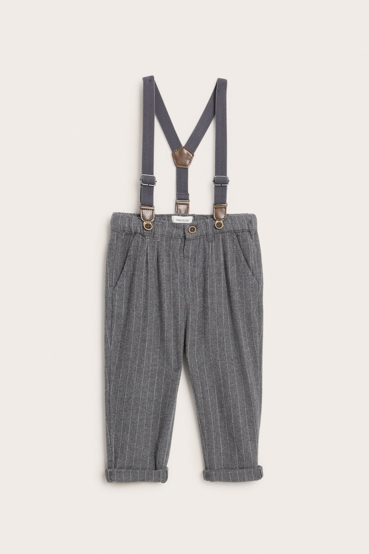 Front view of kid's gray pinstripe trousers with dark gray suspenders and brown leather details.