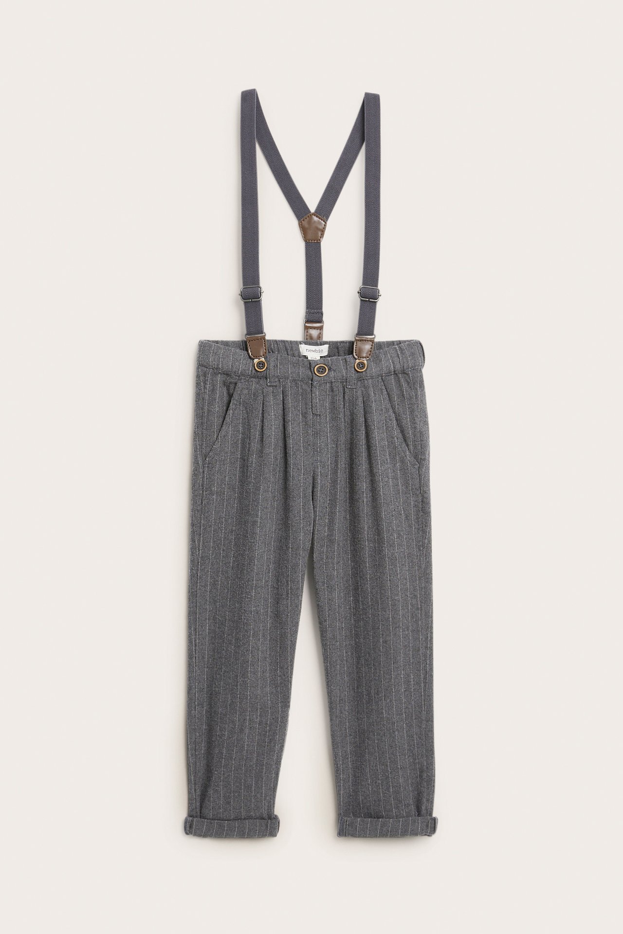Front view of kid's gray pinstripe trousers with cuffed hems and dark gray suspenders.