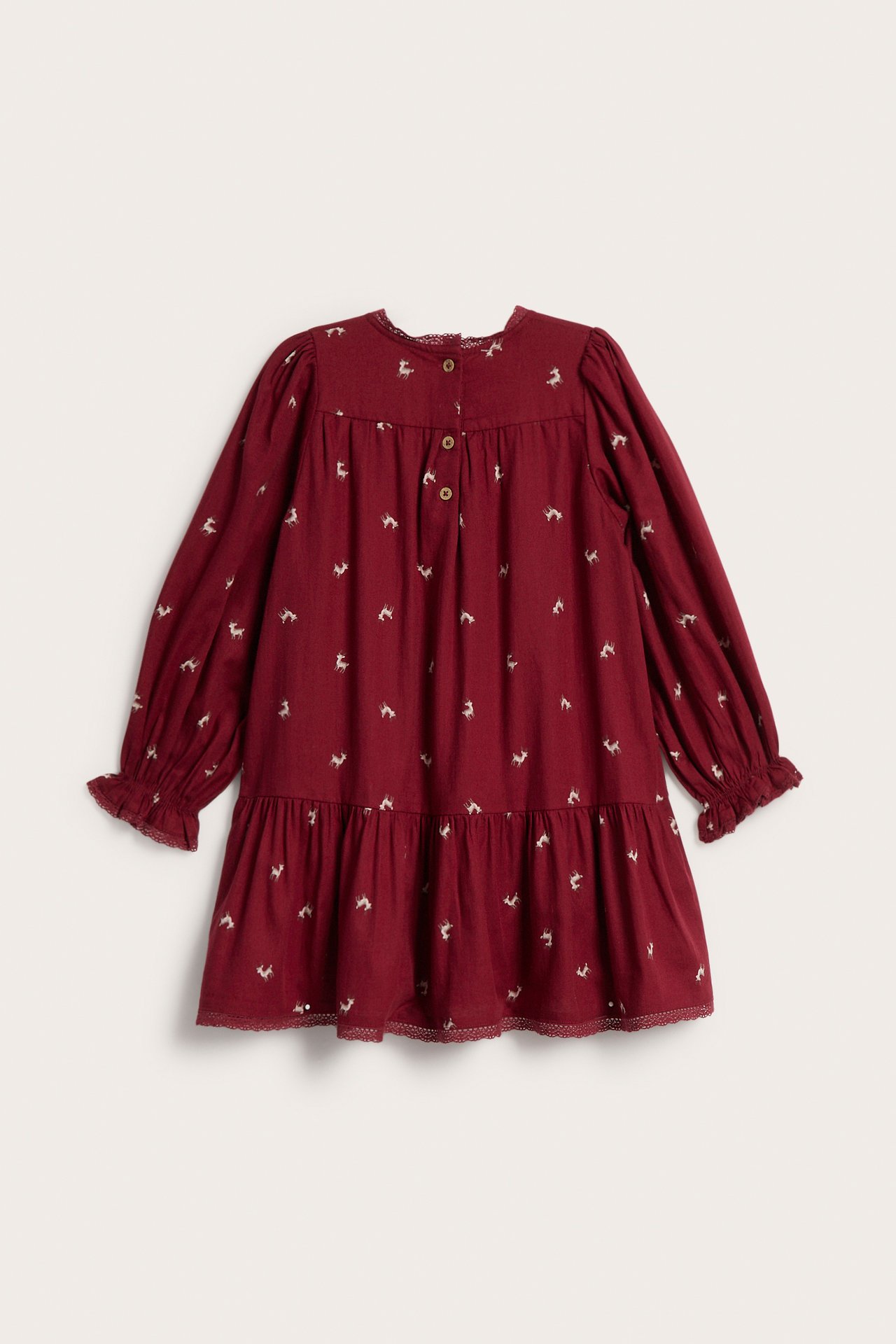 Front view of a kid's burgundy long-sleeved dress with white deer print and tiered ruffle hem.
