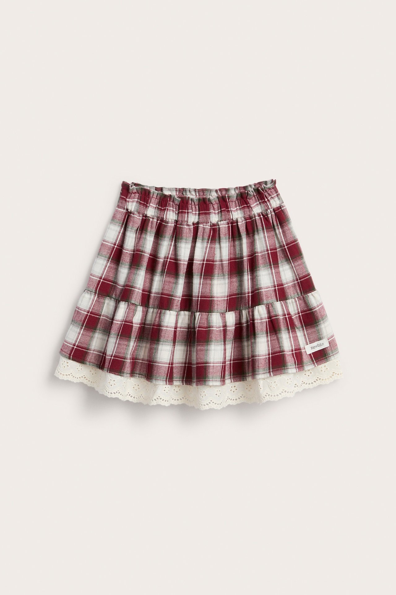 Front view of a kid's red and white plaid tiered skirt with an elasticated waist and lace trim.