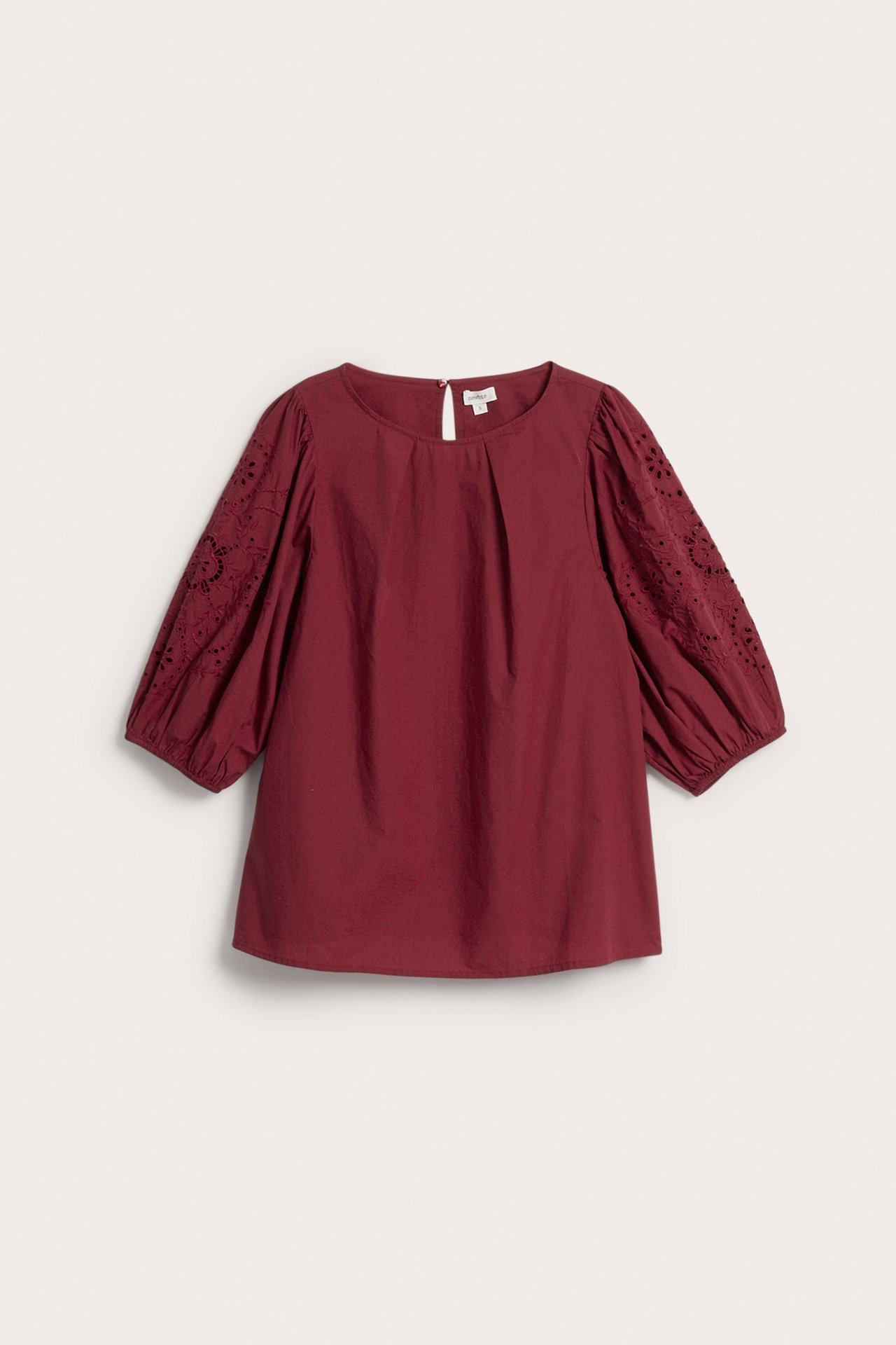 Front view of a maroon round-neck blouse with 3/4 eyelet embroidered puffed sleeves.