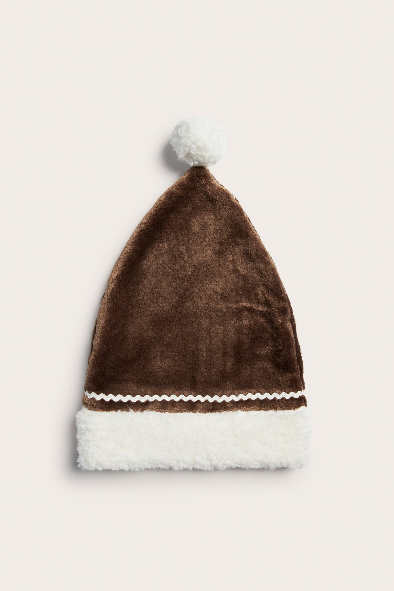 Front view brown plush Christmas hat with white fluffy pompom, brim, and rick-rack trim.