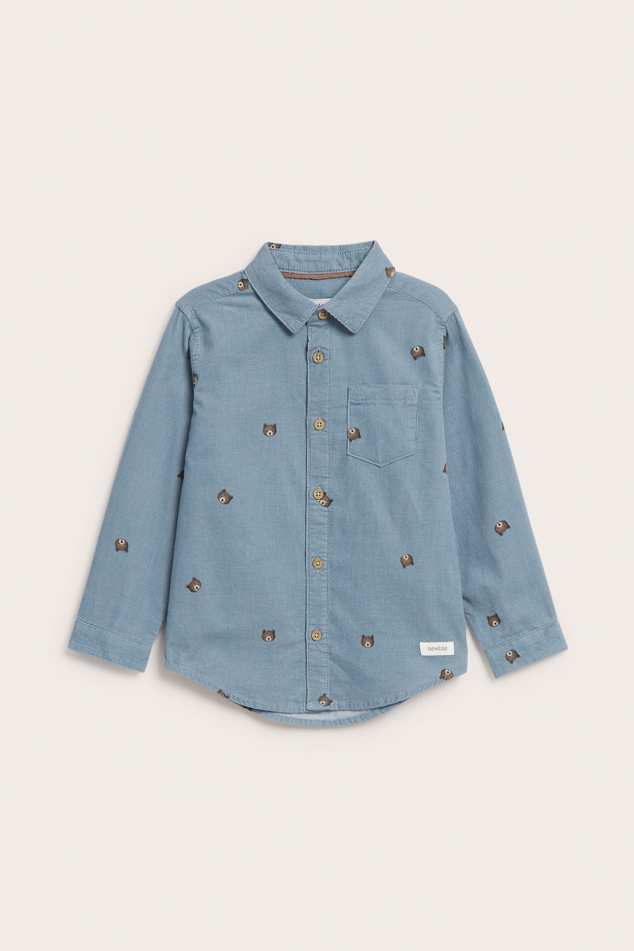 Front view of a kid's light blue long-sleeved shirt with embroidered bear faces and brown buttons.