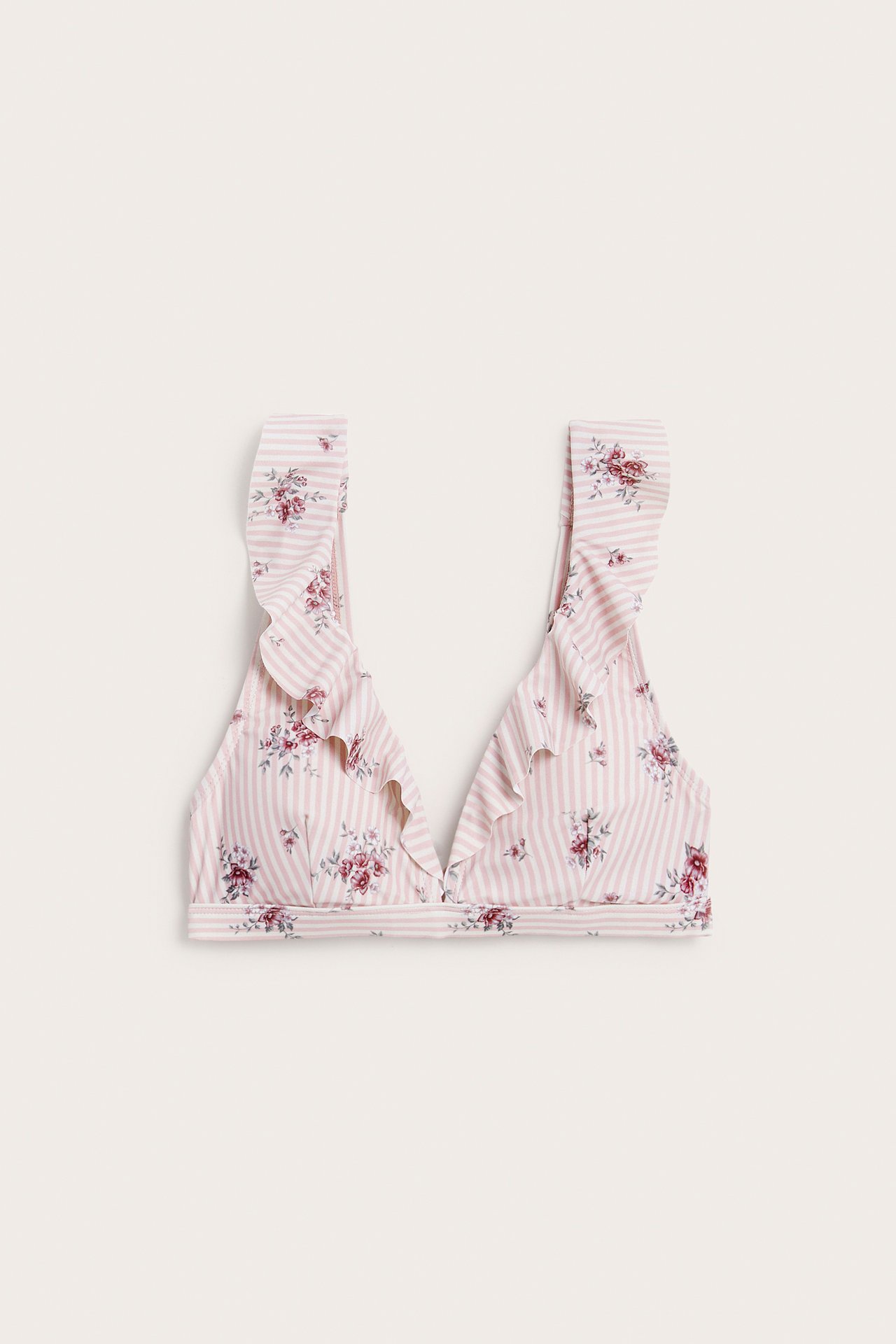 Front view of a pink and white striped bikini top with floral print and ruffles.