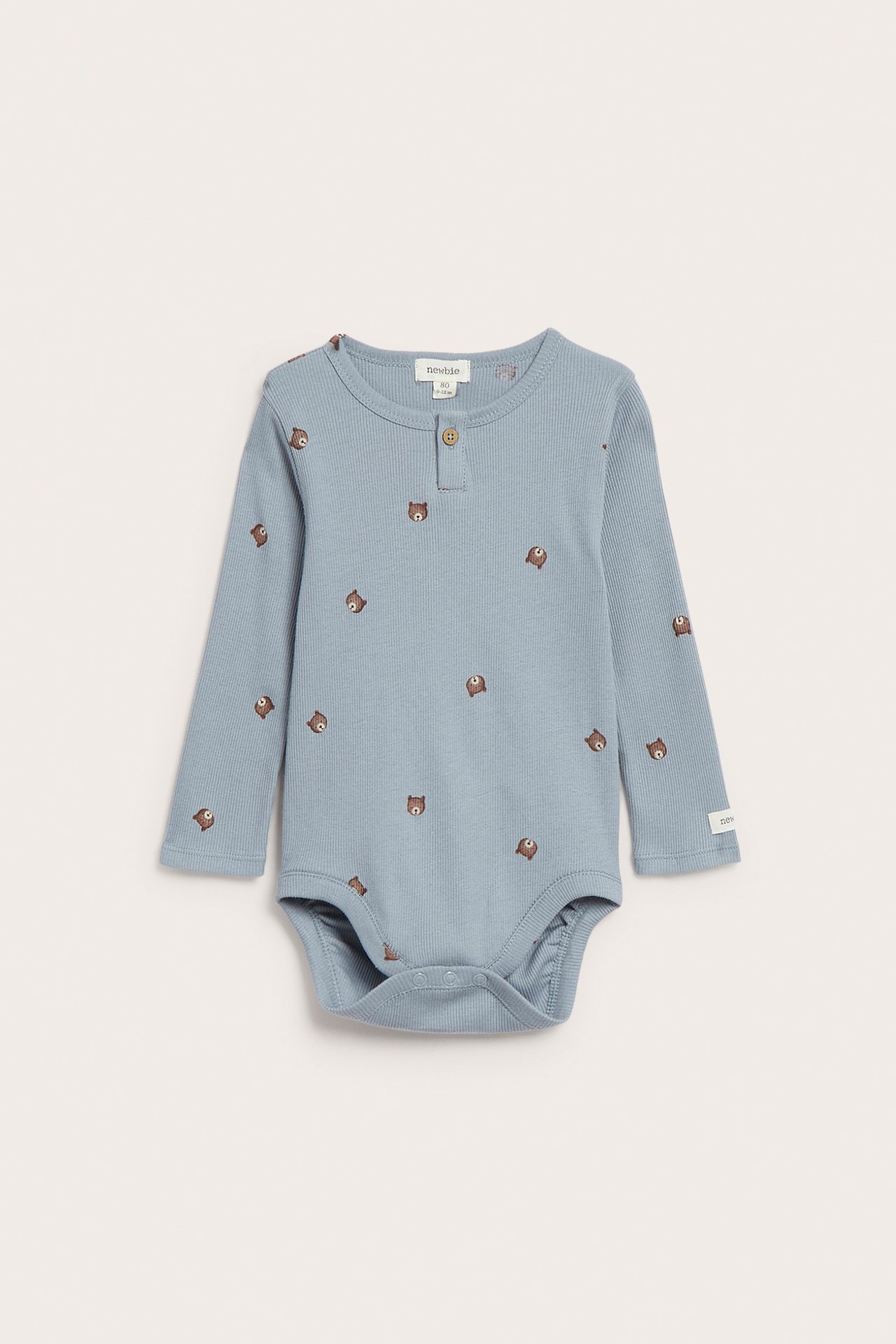 Front view of a light blue ribbed long-sleeved baby bodysuit with bear print, two-button placket, and crotch snaps.