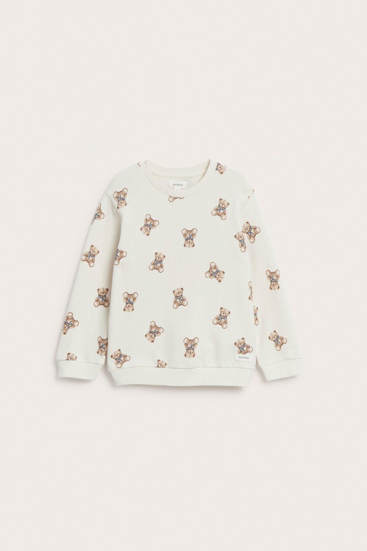 Vorderansicht eines hellbeigen Kindersweatshirts mit durchgehendem braunen Teddybärenmuster.