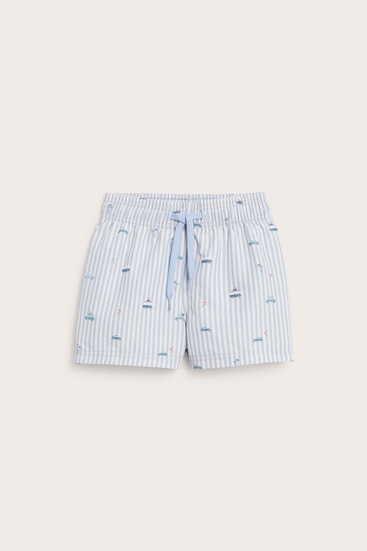 Front view of kid's light blue and white striped swim shorts with small car and boat patterns.