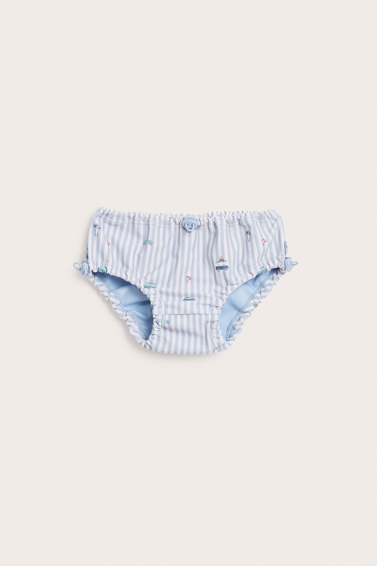 Vorderansicht Baby-Unterhose, blau-weiß gestreift mit Sommermotiven und Rüschendetails.