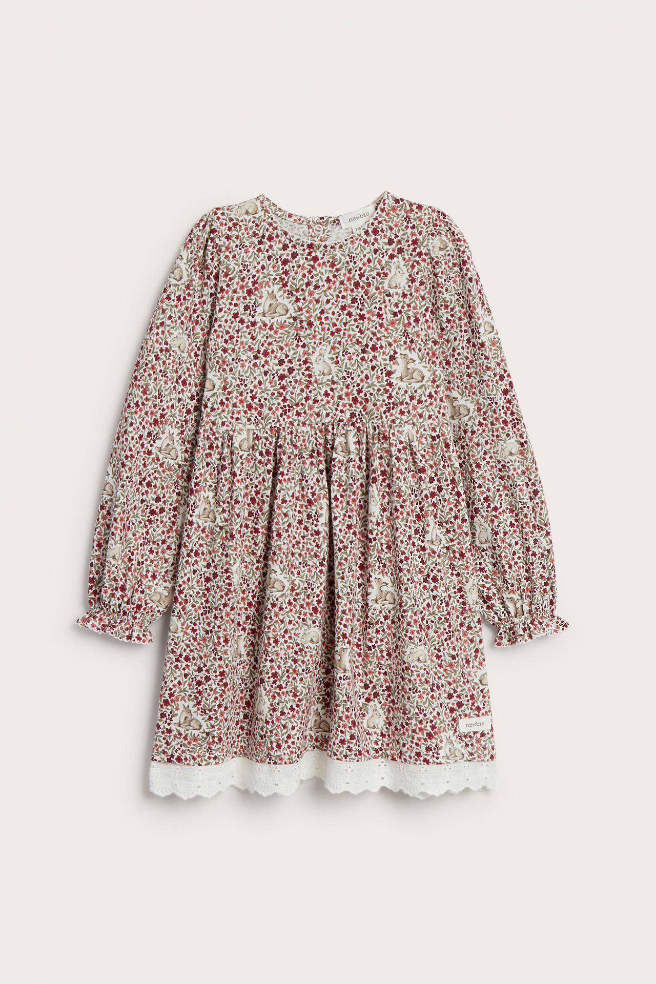 Front view of a kid's long-sleeved floral and bunny print dress with white lace trim.