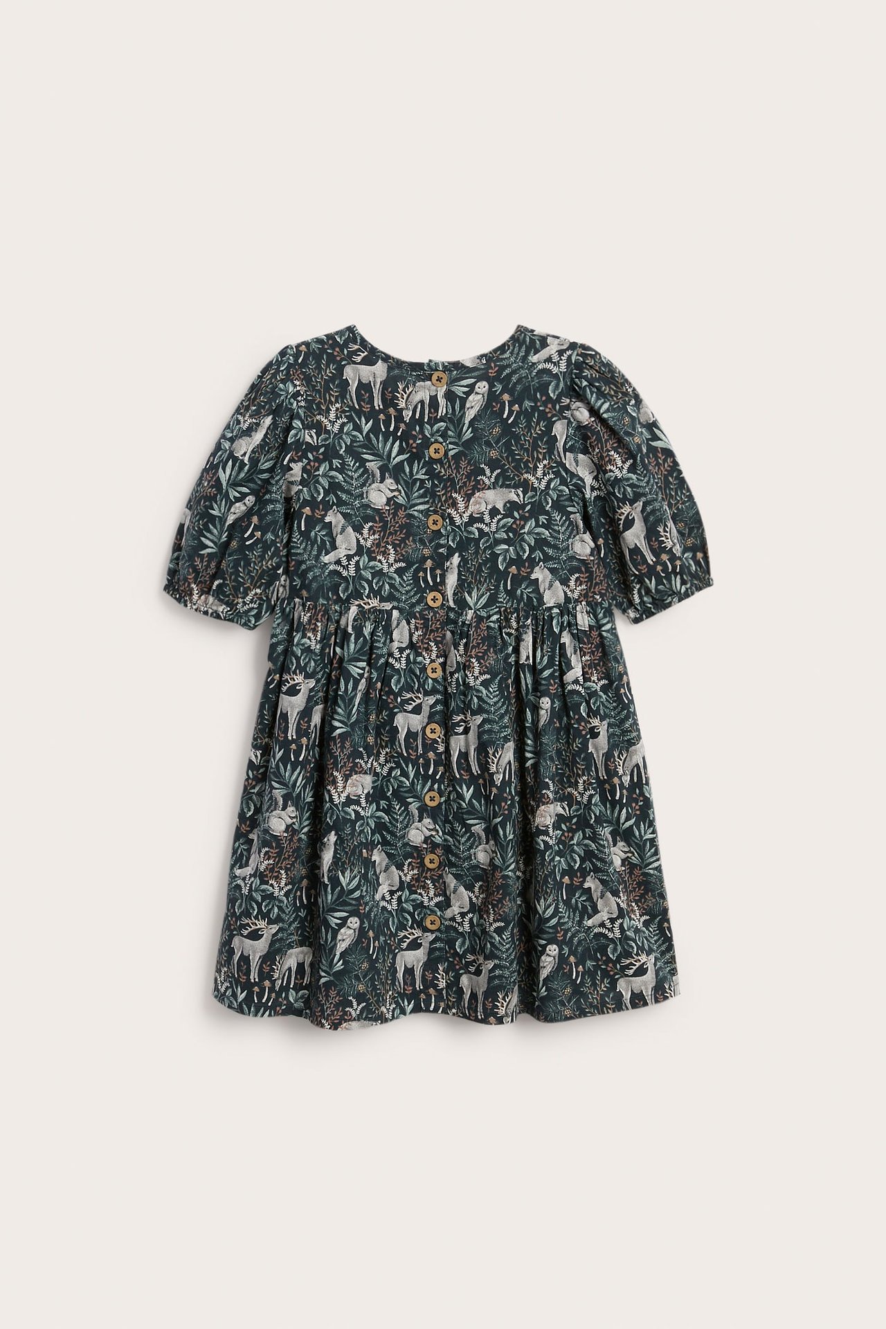 Front view of a kid's dark green woodland animal print dress with short puffed sleeves and buttons.