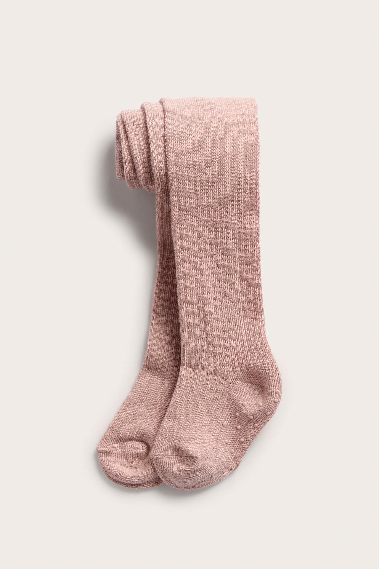 Draufsicht, rosa gerippte Baby-Strumpfhose mit Anti-Rutsch-Noppen an den Sohlen.