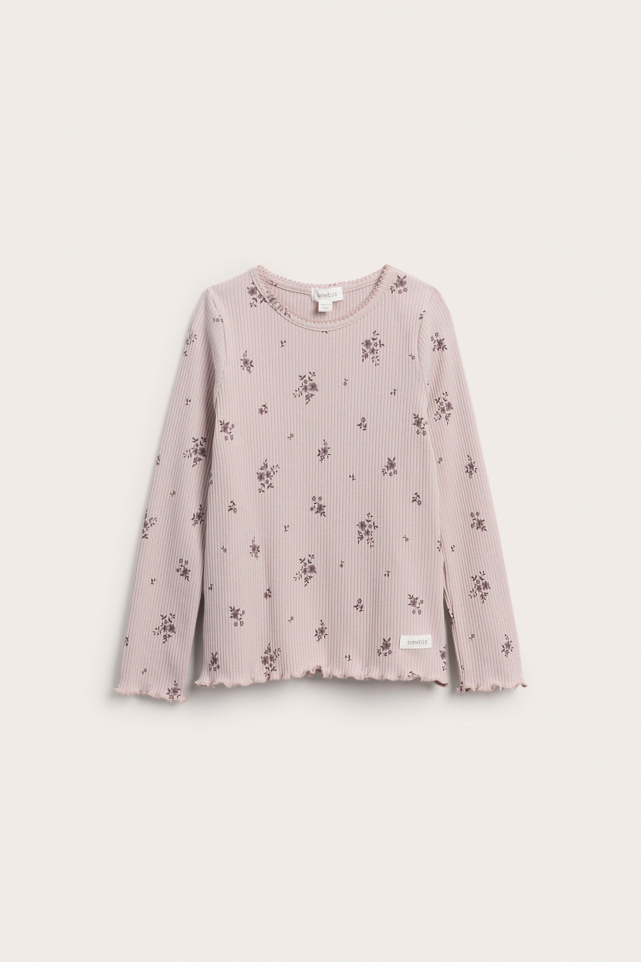 Front view of a kid's ribbed long-sleeve top in light purple with a scattered floral print.