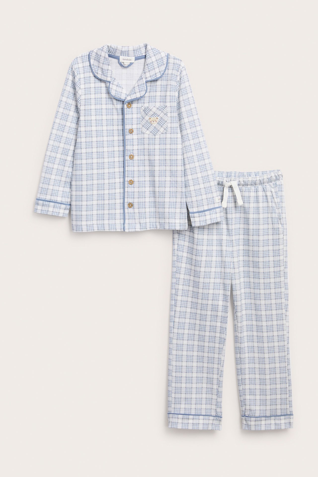 Front view: Kid's blue and white checked pajama set with piped button-front shirt and drawstring pants.
