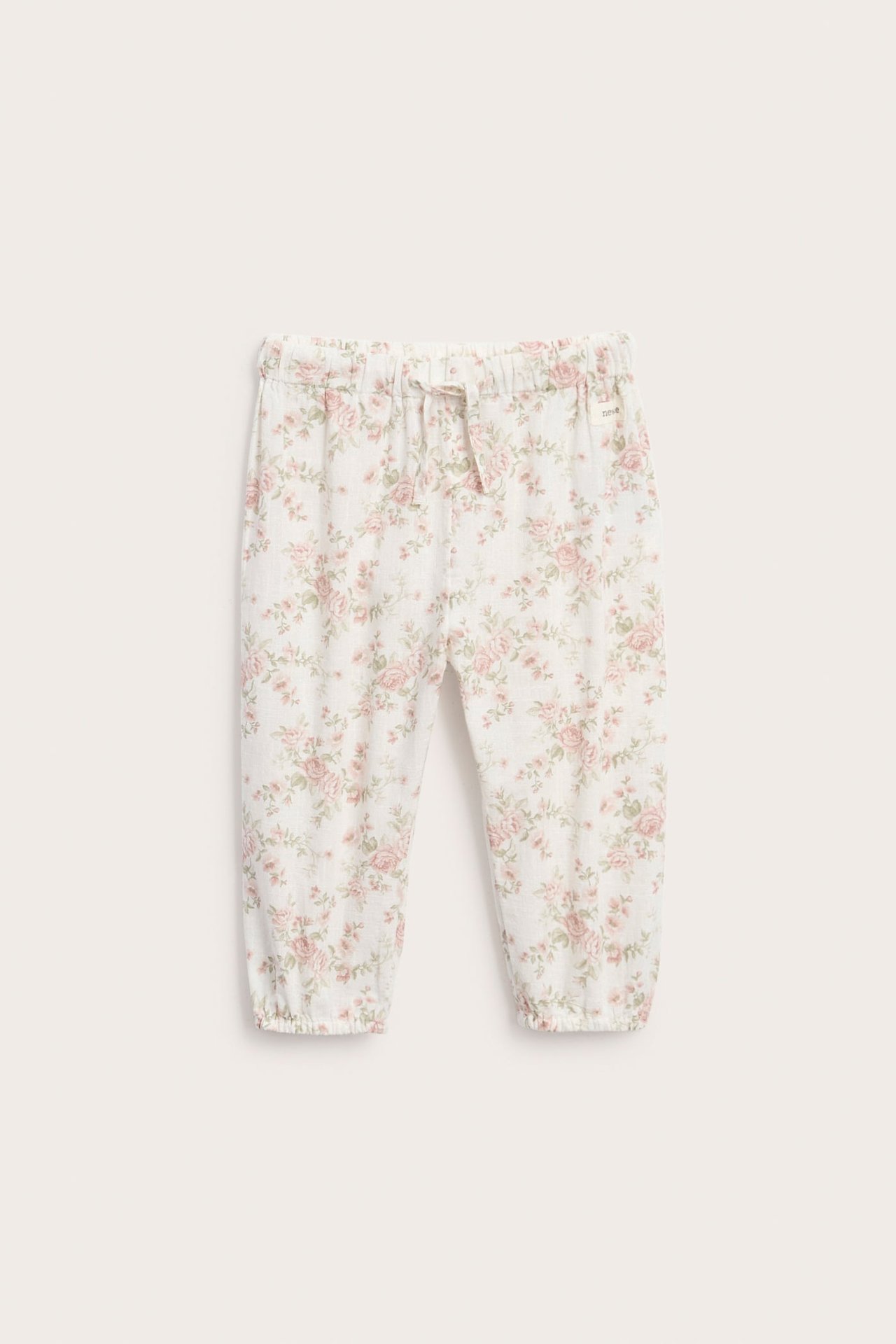 Front view of baby white floral print pants with elasticated waist and cuffs.